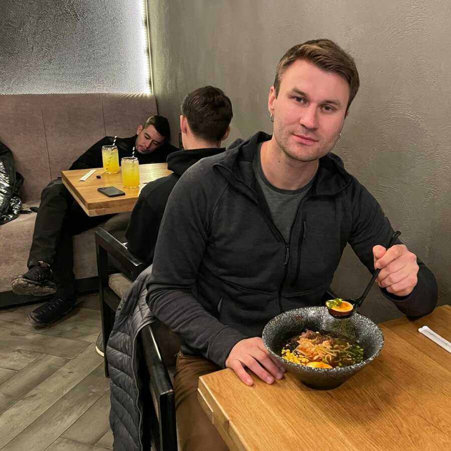 Ukrainian man eats ramen at favorite restaurant.