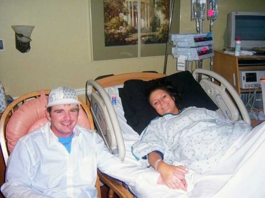 mom and dad in the hospital waiting for their son to be born, both have huge smiles on their face