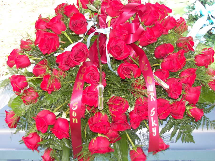 red roses with ribbon from the funeral of a baby who died from S.I.D.S.