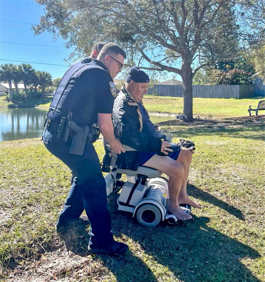 Police officer and neraby bystanders help rescue elderly man drowning in lake. 