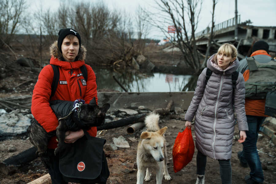 Young Ukrainian couple flees with dogs.