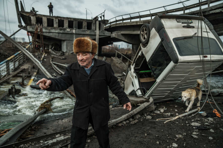 Old Ukrainian man makes his way through the rubble.