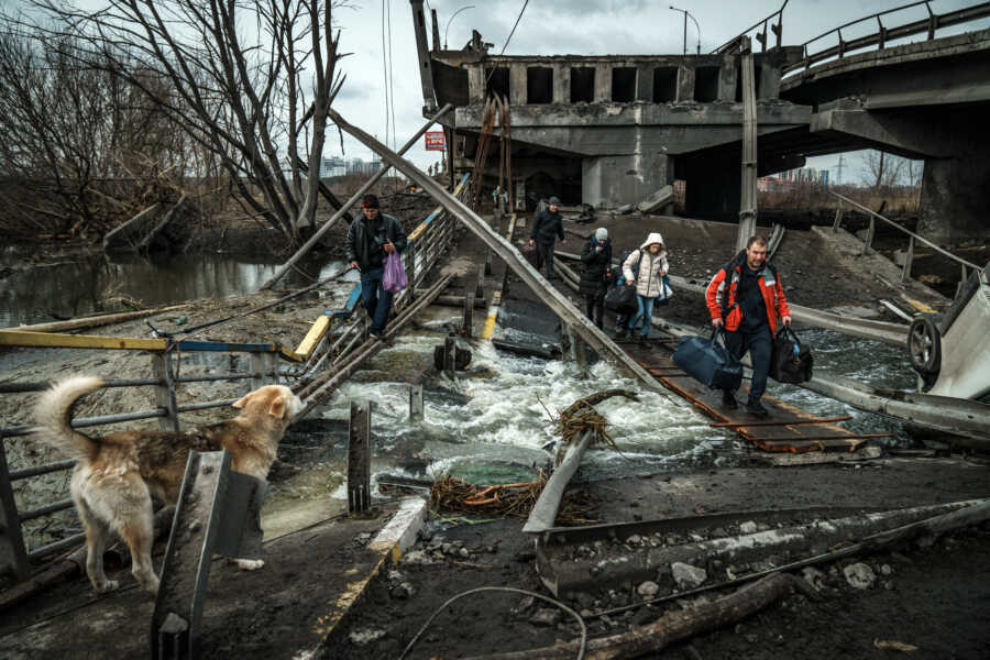 Family flees through the rubble and destruction.