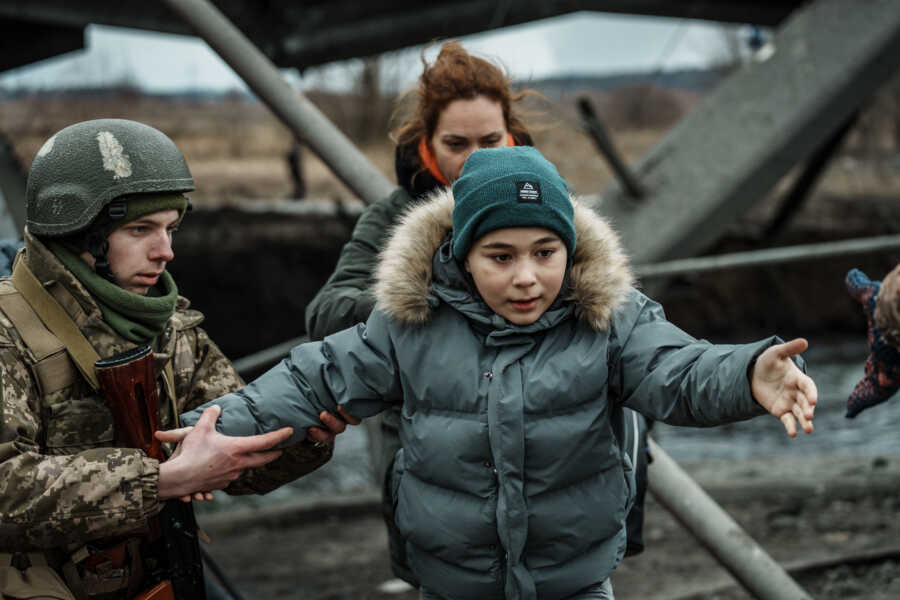 Young boy makes his way through the rubble.