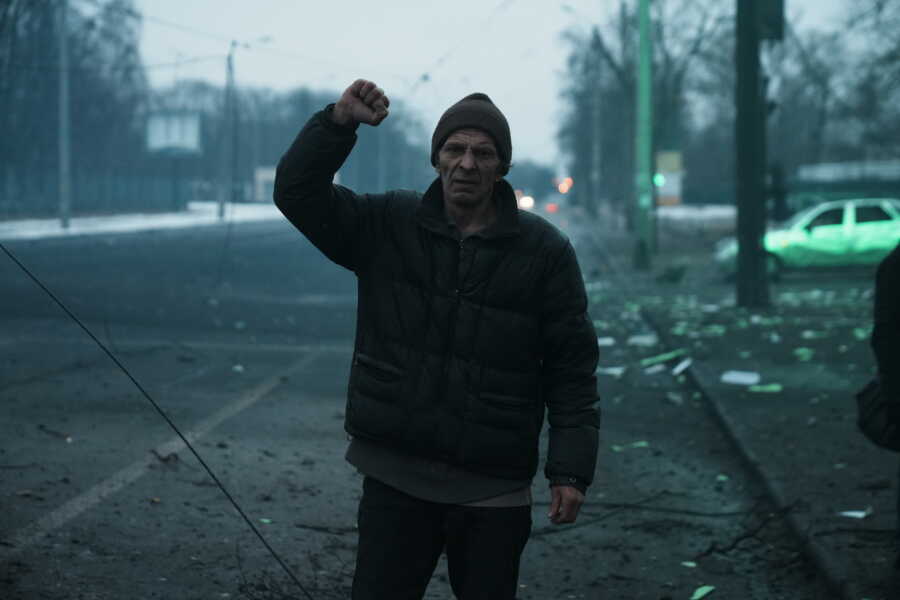 Ukrainian man raises his fist in determination.