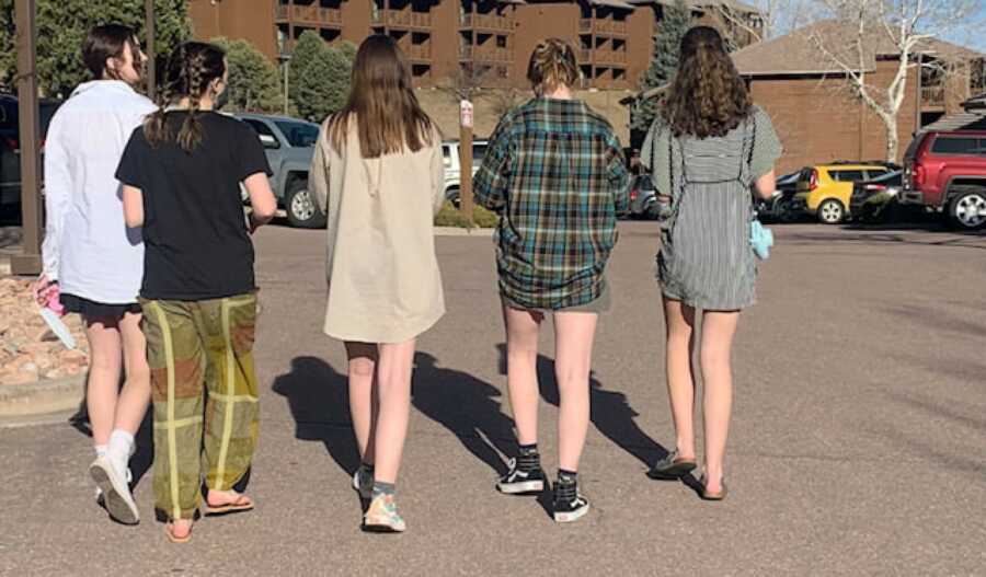 group of teenage girls walking across the parking lot
