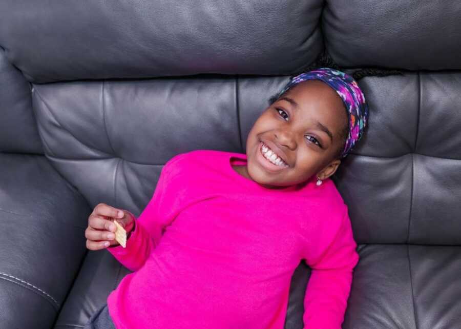 little girl in a bright pink shirt who defended a classmate