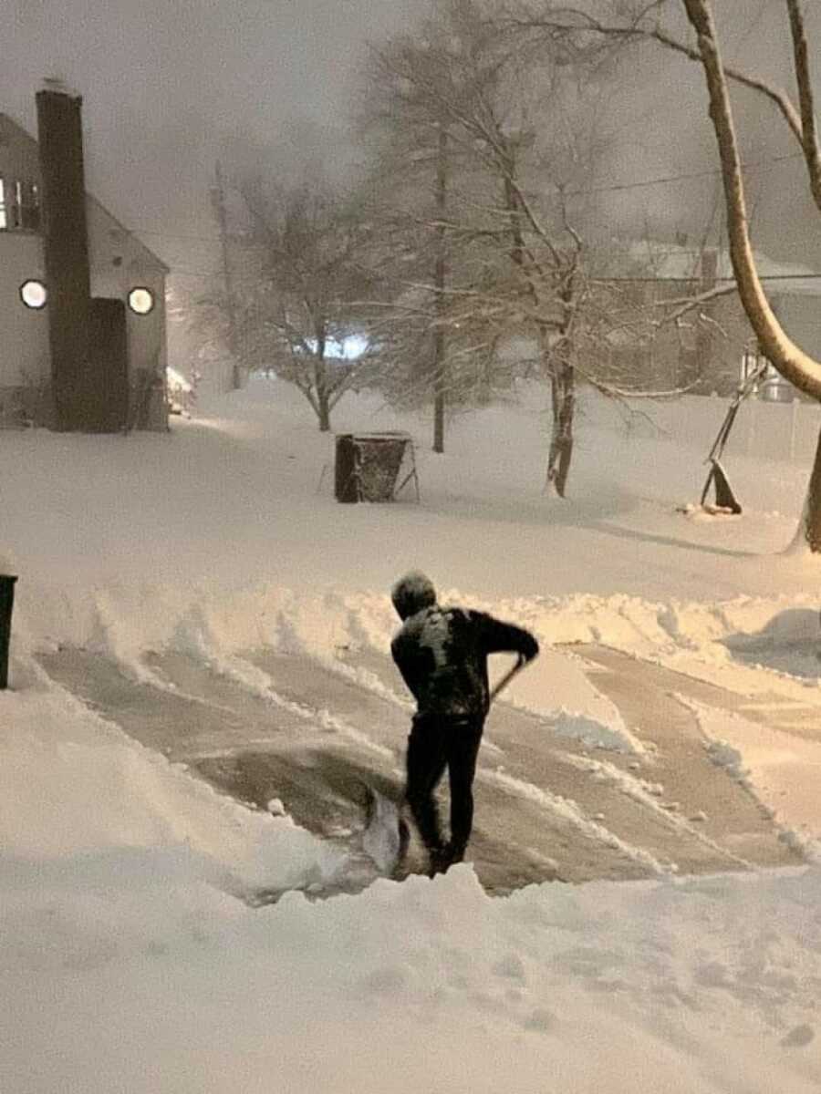 man out in the early morning hours shoveling snow