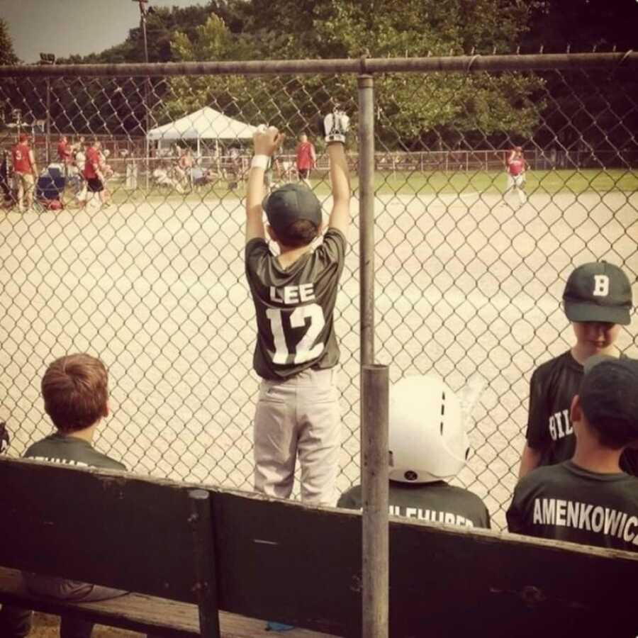 little boy playing baseball in uniform