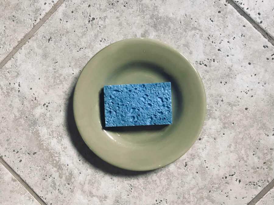 sponge on a plate that is on tile 