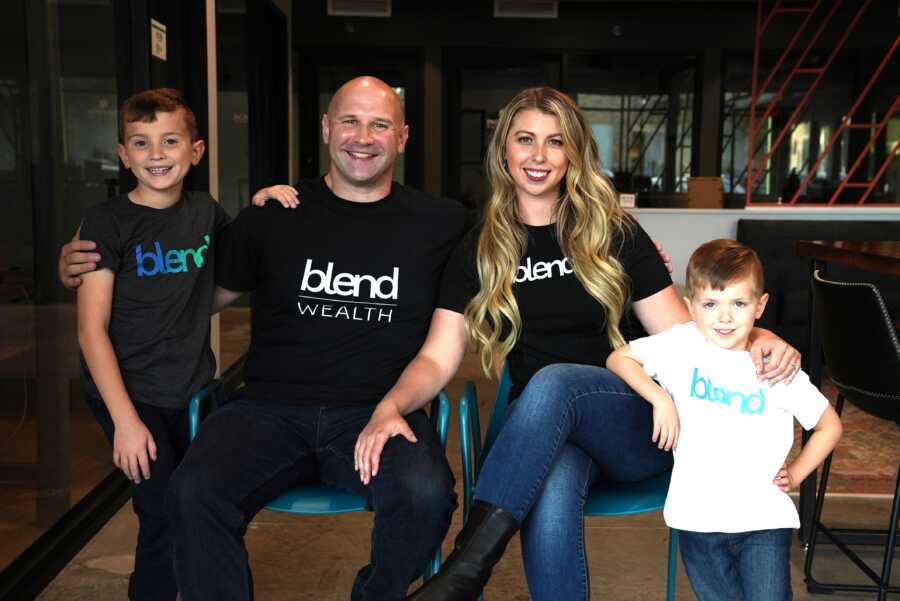 Couple running their own financial planning business take a photo in matching shirts with their two sons