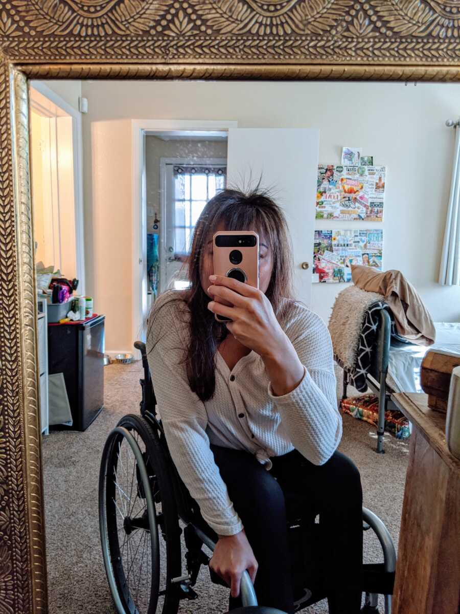 Paraplegic takes a mirror selfie from her wheelchair, showing her new hair growth