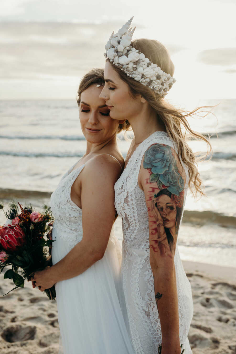 Wedding photography of Lesbian couple wearing white dresses at the beach 