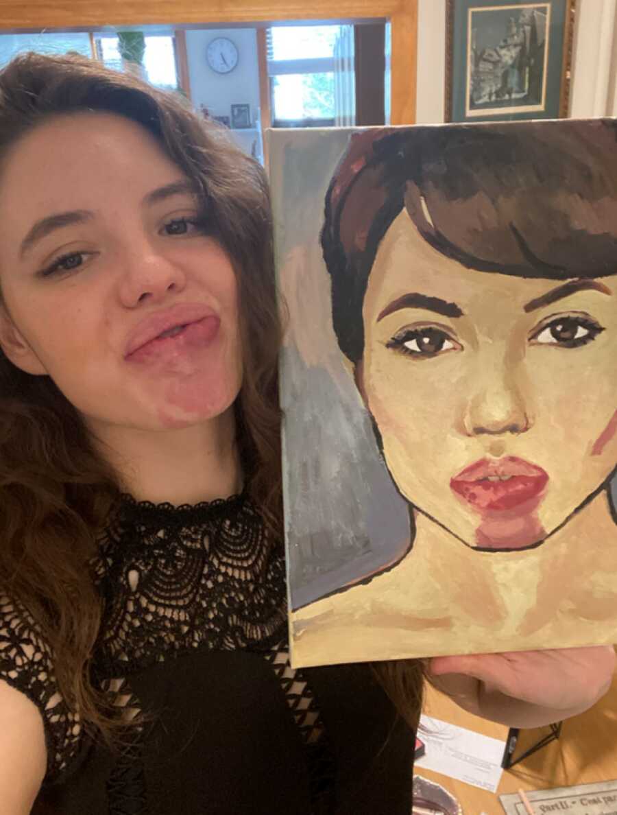 artist smiling with a painting
