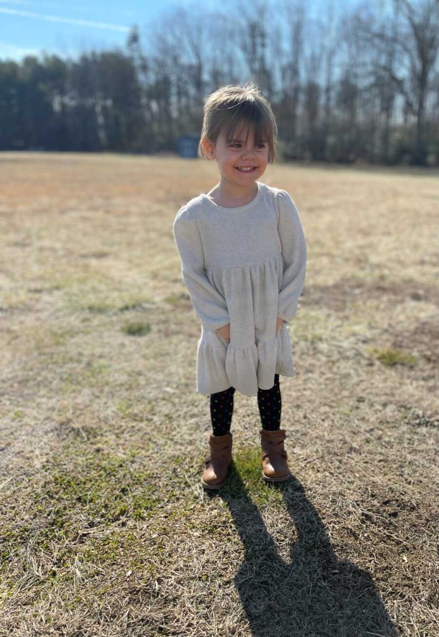 little girl in a dress in a field