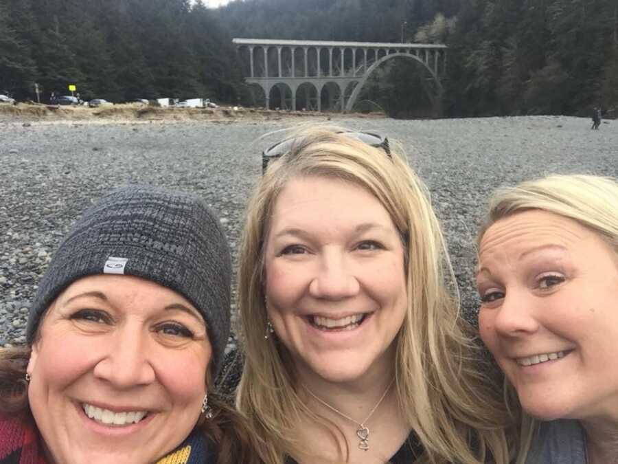 selfie of women in front of bridge