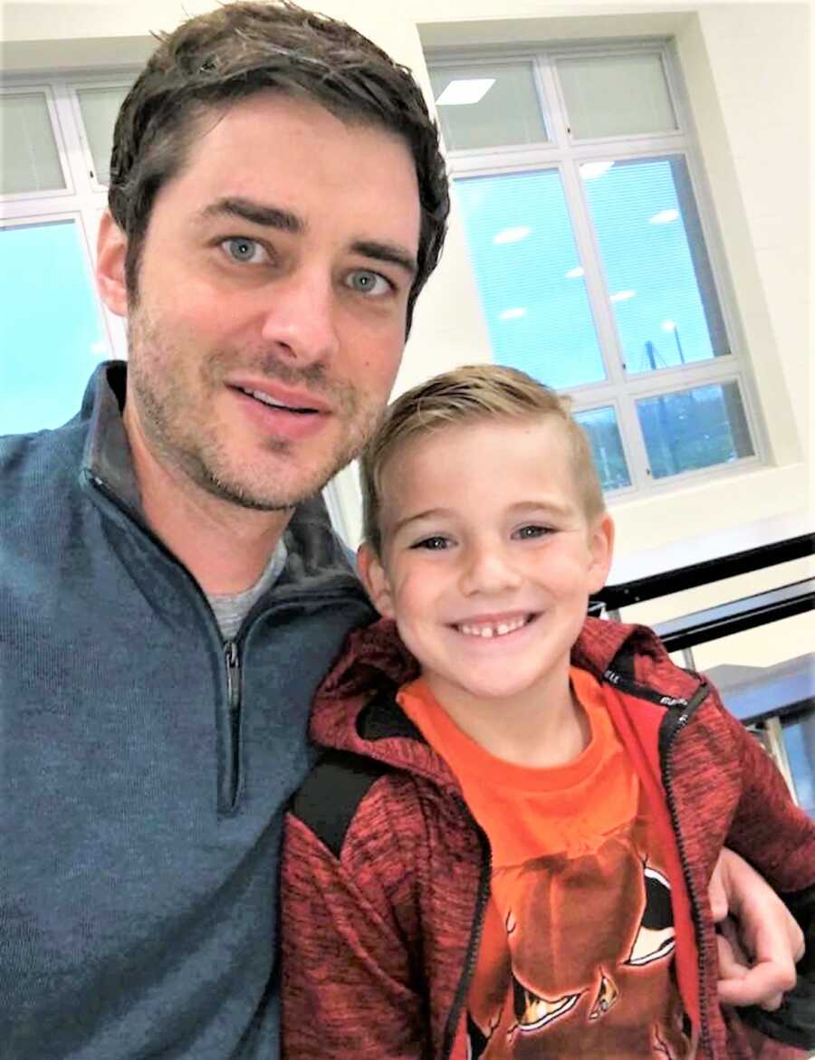 selfie of father and son smiling while sitting 