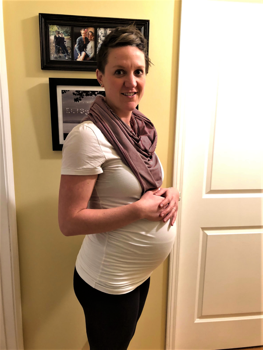 woman standing posing for a pregnancy photo