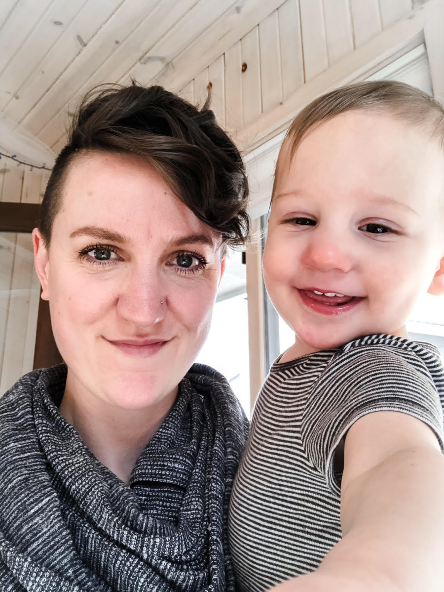 mom holding son smiling and happy