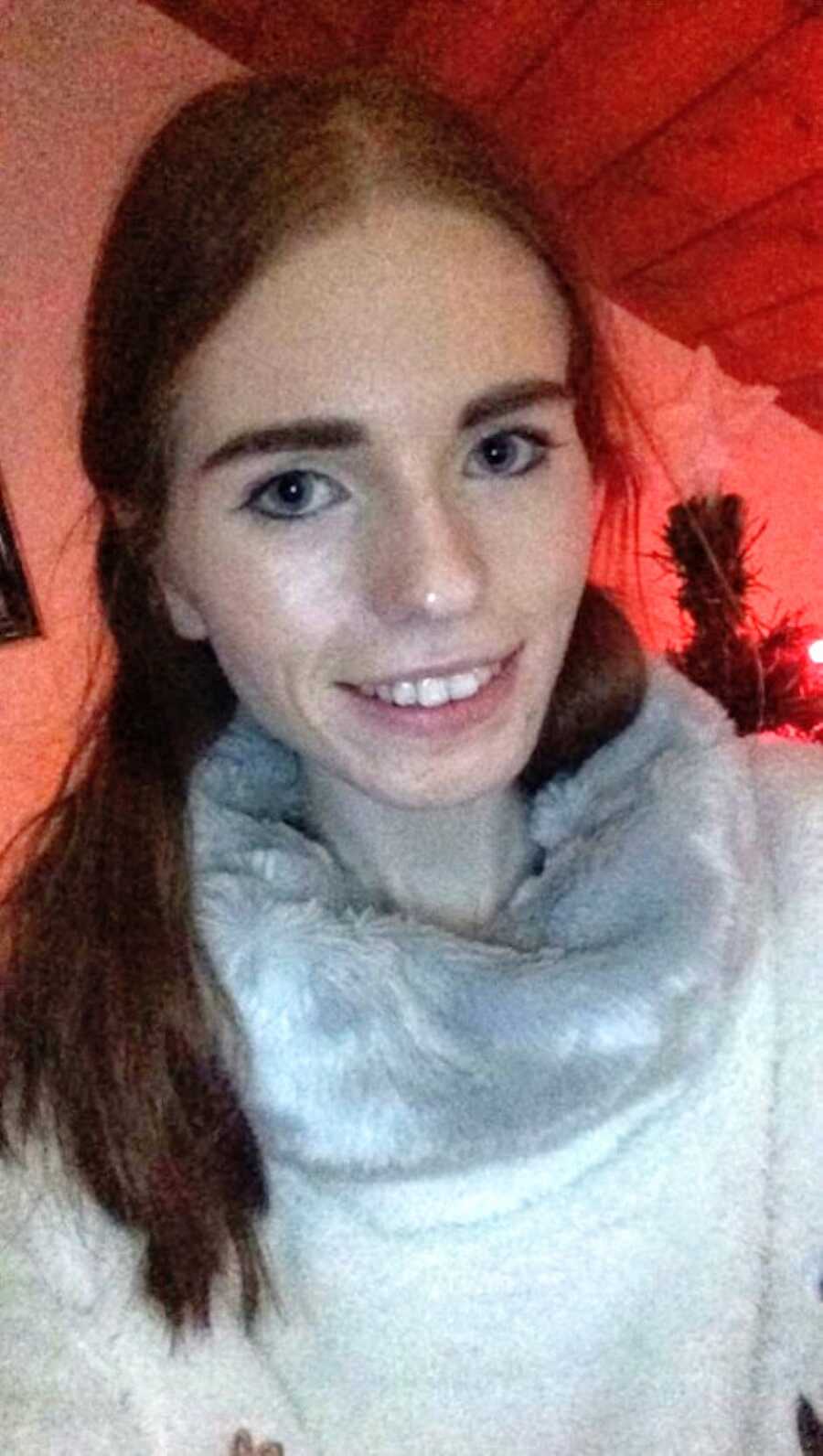 Woman battling anxiety and an eating disorder takes a selfie while wearing a turtleneck to stay warm