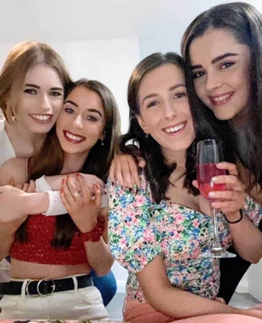 Woman recovering from an eating disorder takes a group photo with her friends on a night out