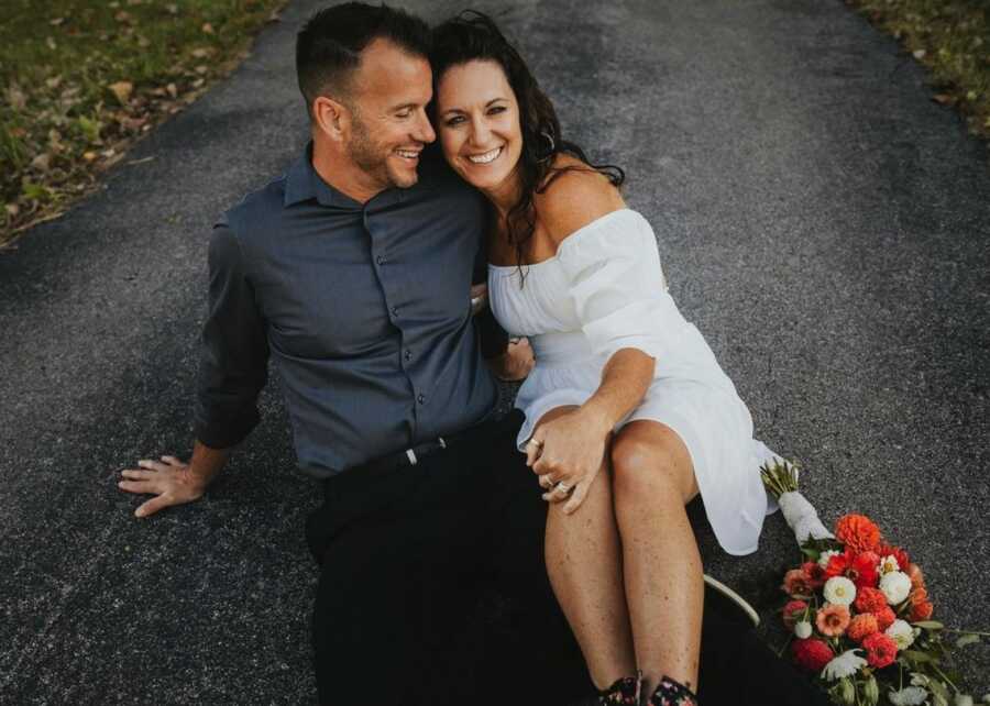 husband and wife sitting together smiling and laughing