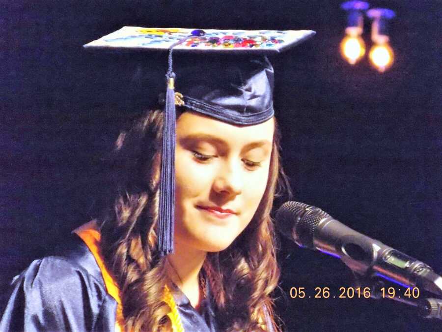 teenage girl giving a speech at her high school graduation