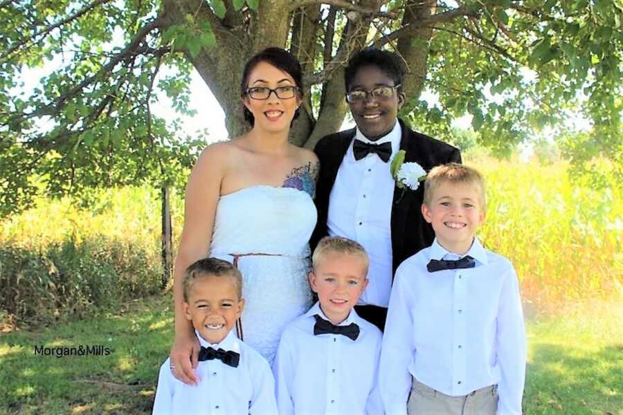 Lesbian couple take photos with their three sons on their wedding day