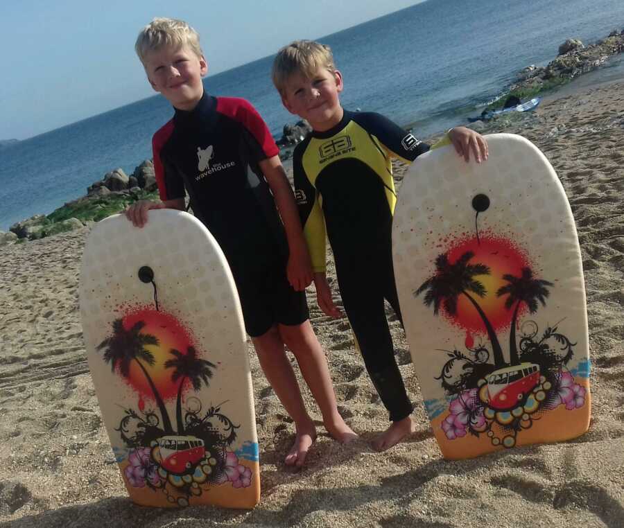 brothers holding boogie boards