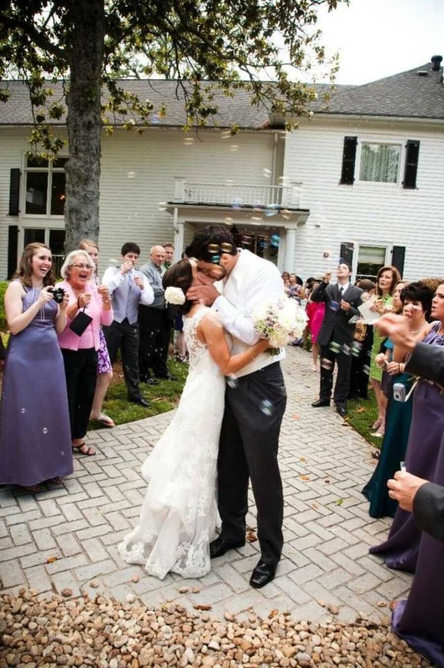 couple sharing a kiss at their wedding