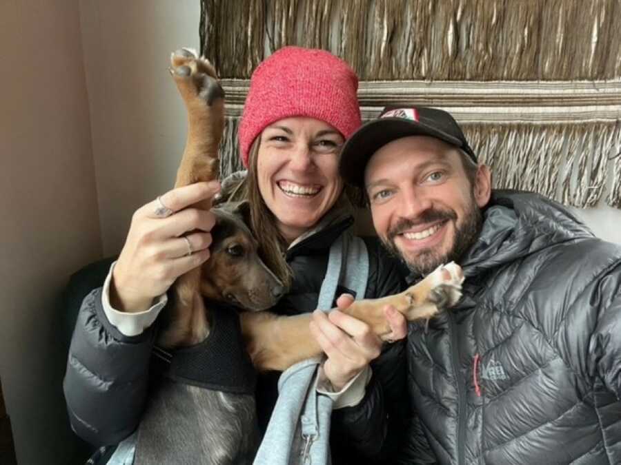 couple smiling their dog