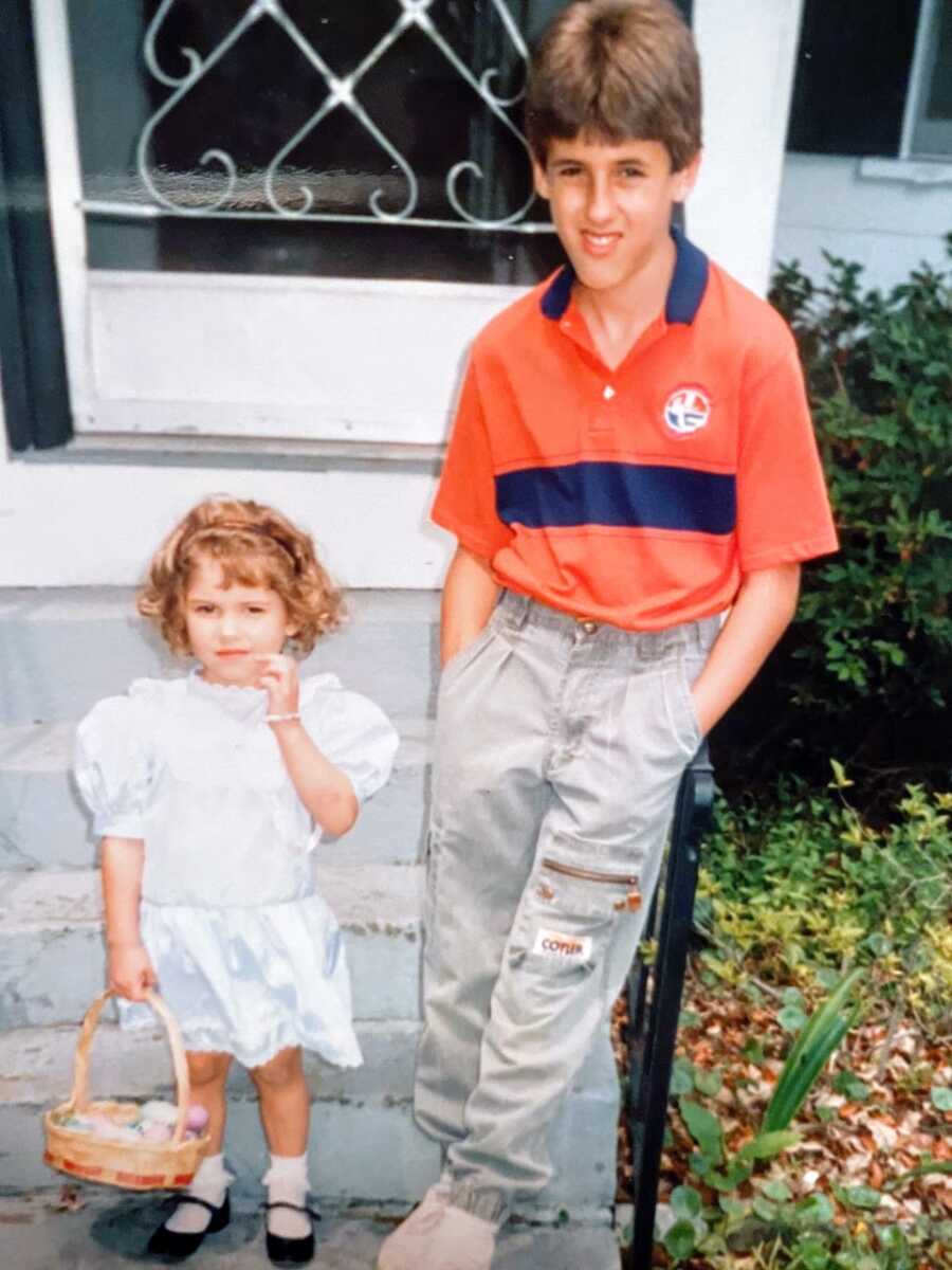 Adoptive sister stands next to her brother on Easter with an Easter basket in her hand