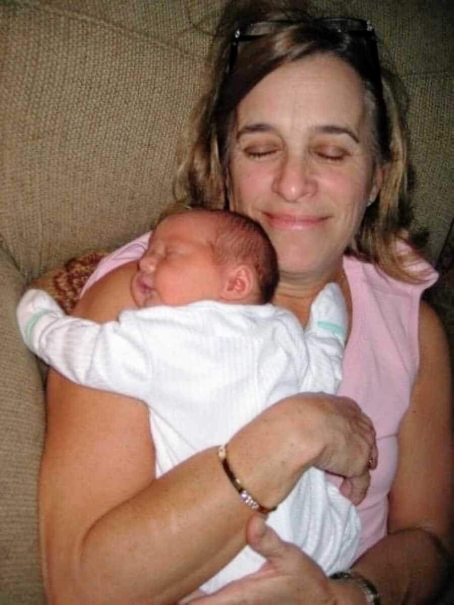 Grandma snuggles with her newborn grandson
