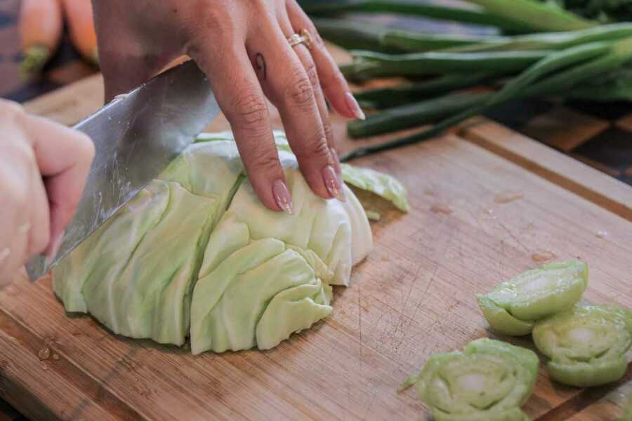 chopping cabbage on cutting board