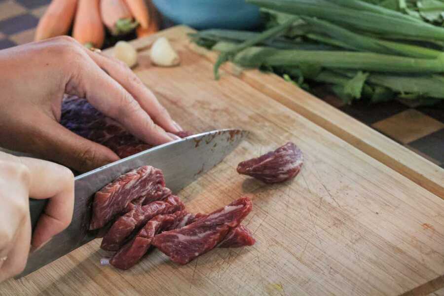 cutting beef into bite size pieces