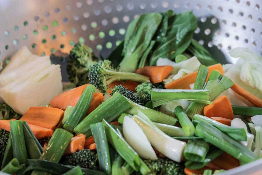 chopped up vegetables in strainer