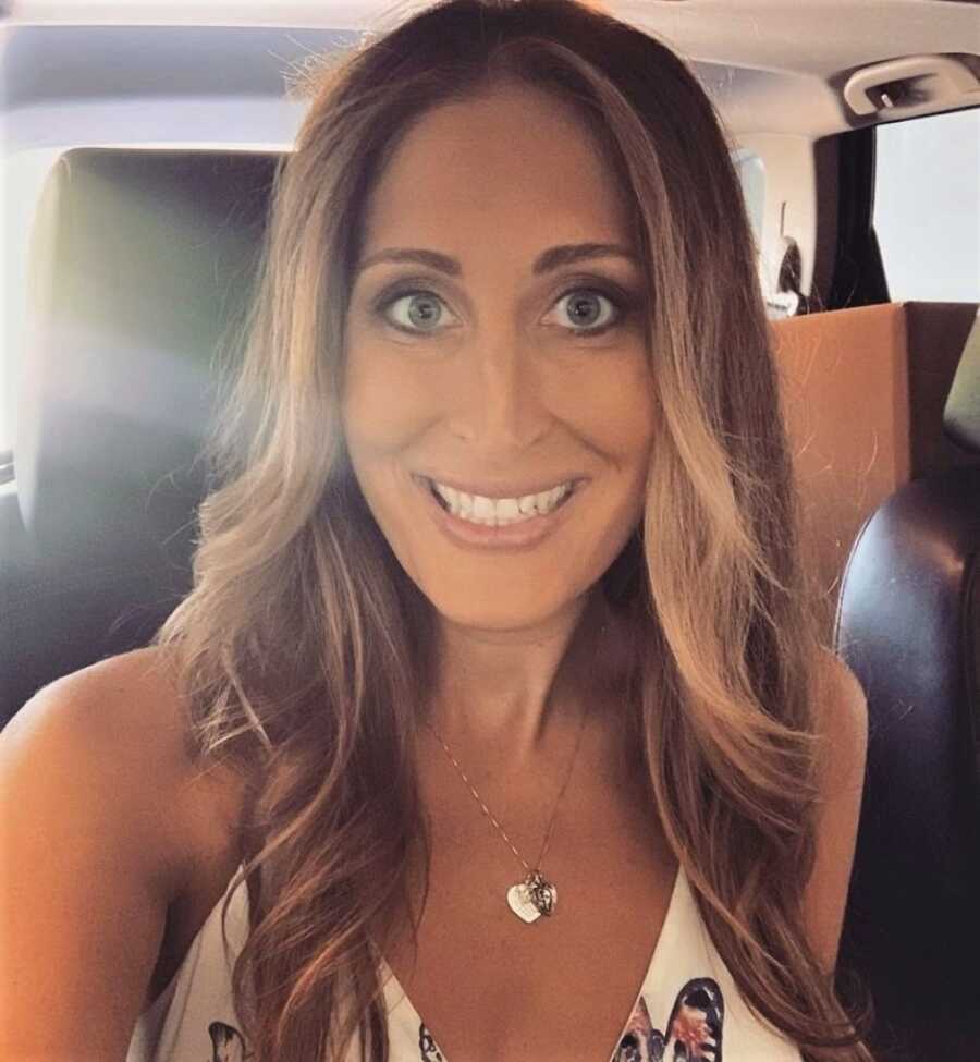 woman smiling and taking a selfie