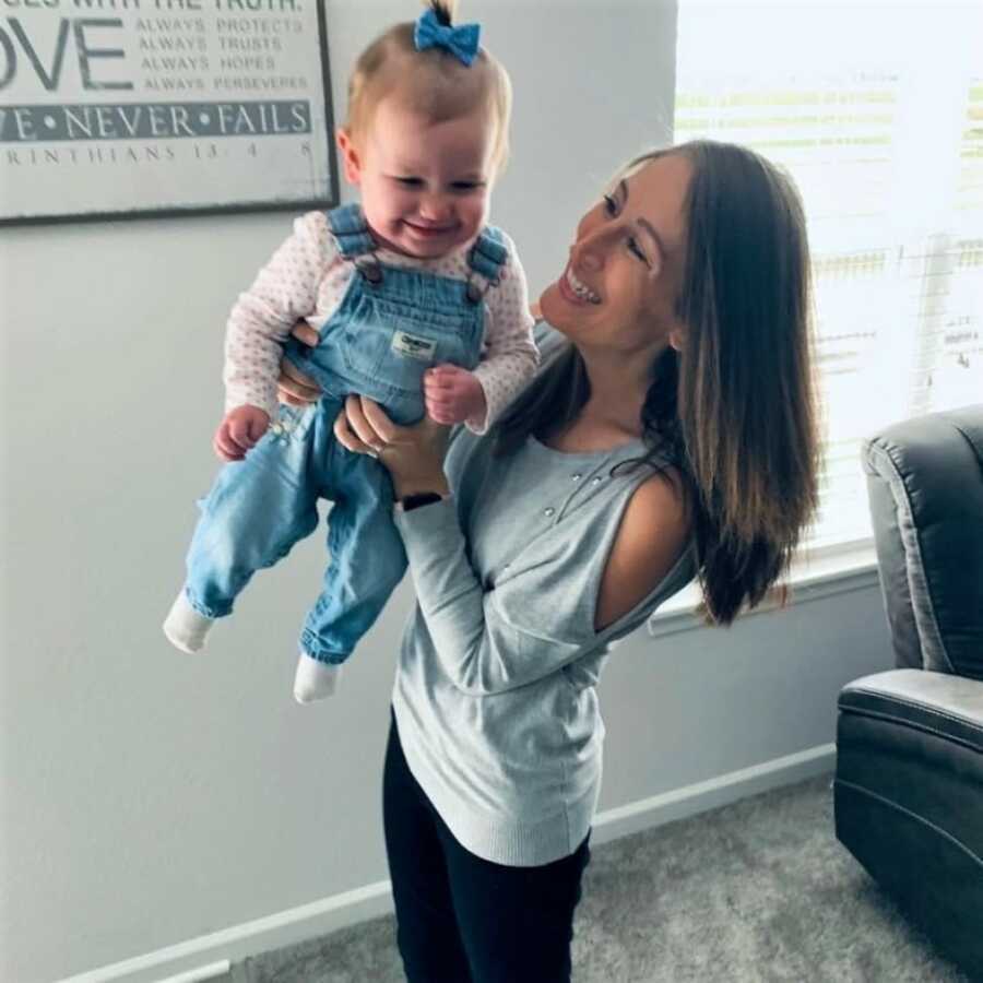 woman holding her rainbow baby