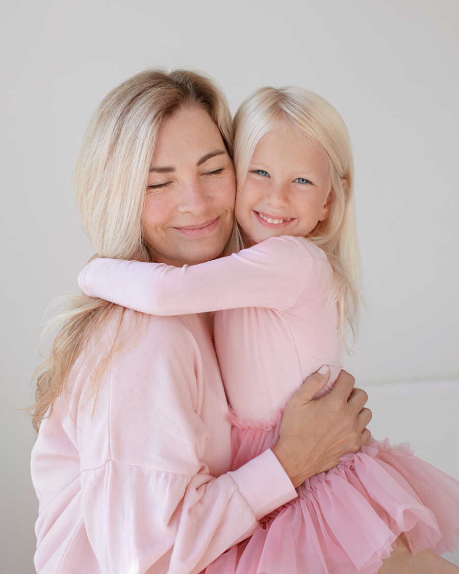 mom hugging her miracle daughter at an older age