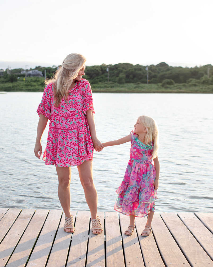 mom with miracle her daughter on a pier 