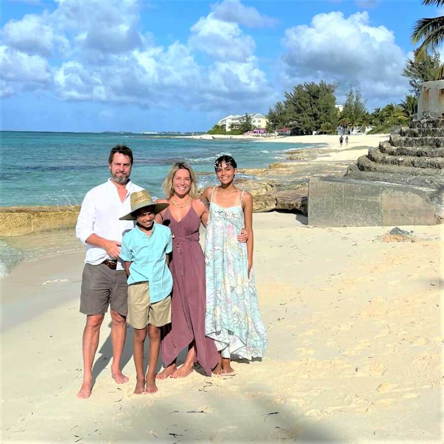 portrait of dad, stepmom and two step kids at the beach during a family vacation