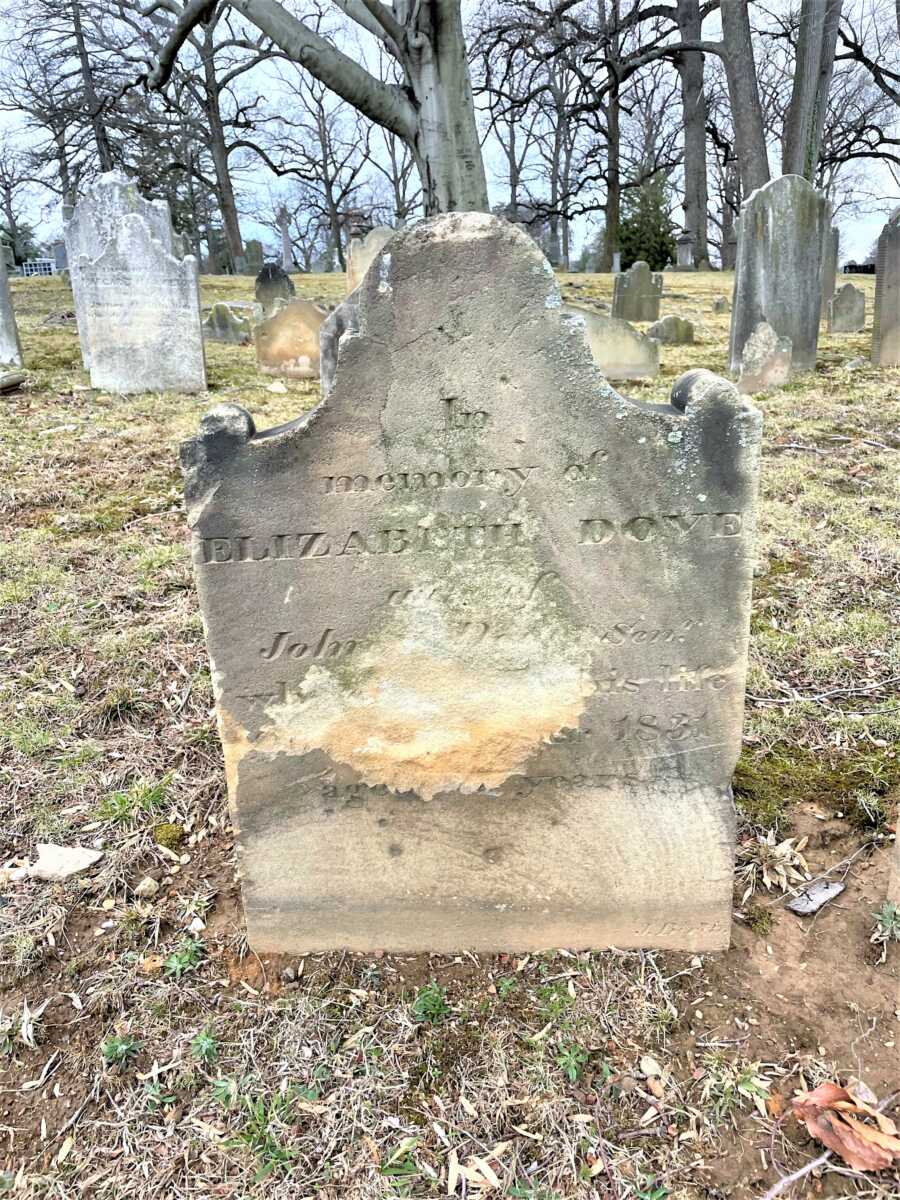 Old gravestone at the cemetery that says "In memory of Elizabeth D..."