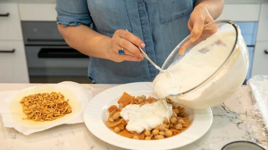 pouring the yogurt on the chickpeas