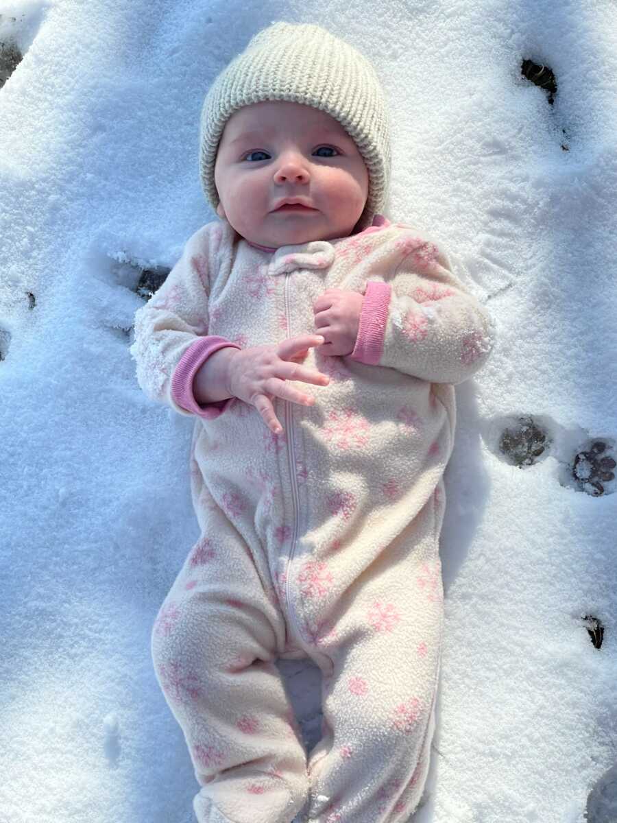 baby girl in the snow happy