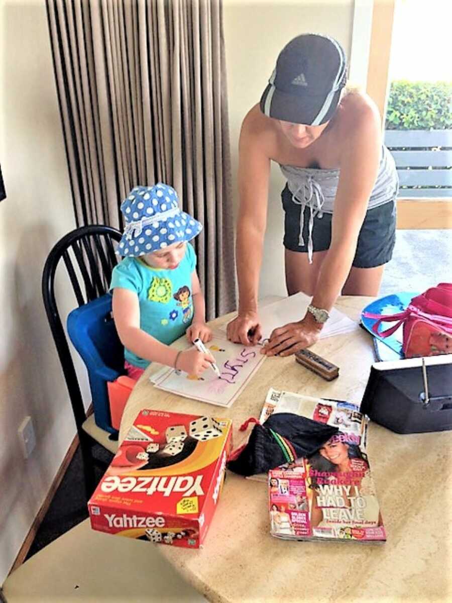 mom teaching her young daughter how to spell 