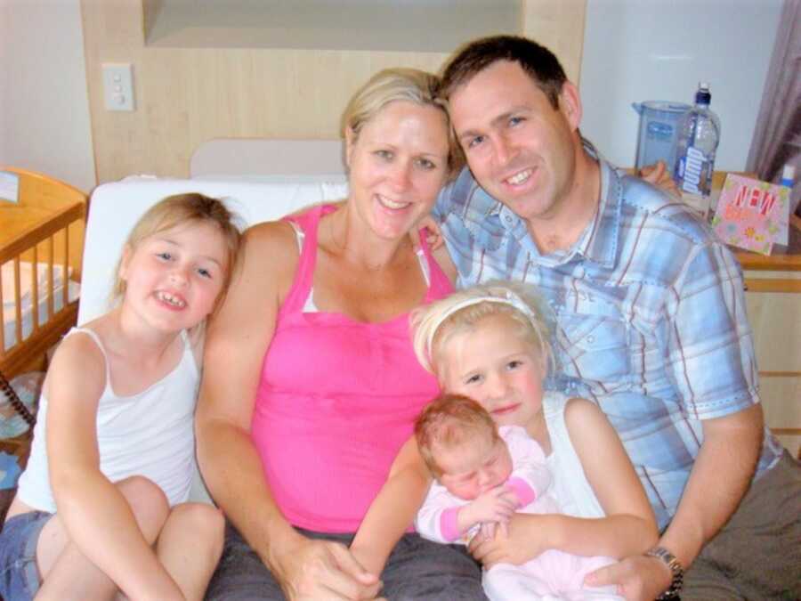 Postpartum mom with newborn baby girl, two older daughters and husband 