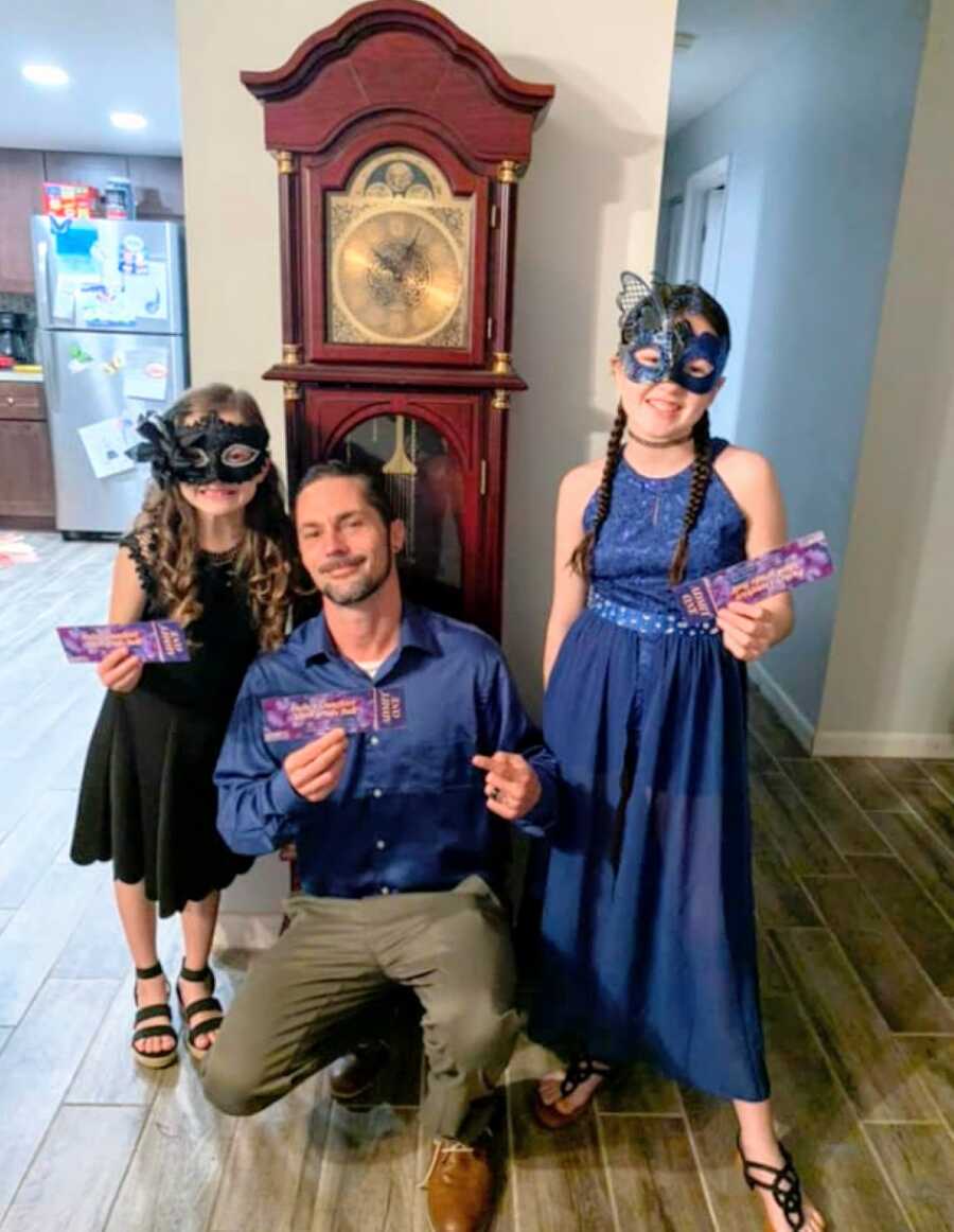 Dad takes his two daughters to a masquerade-themed daddy daughter dance