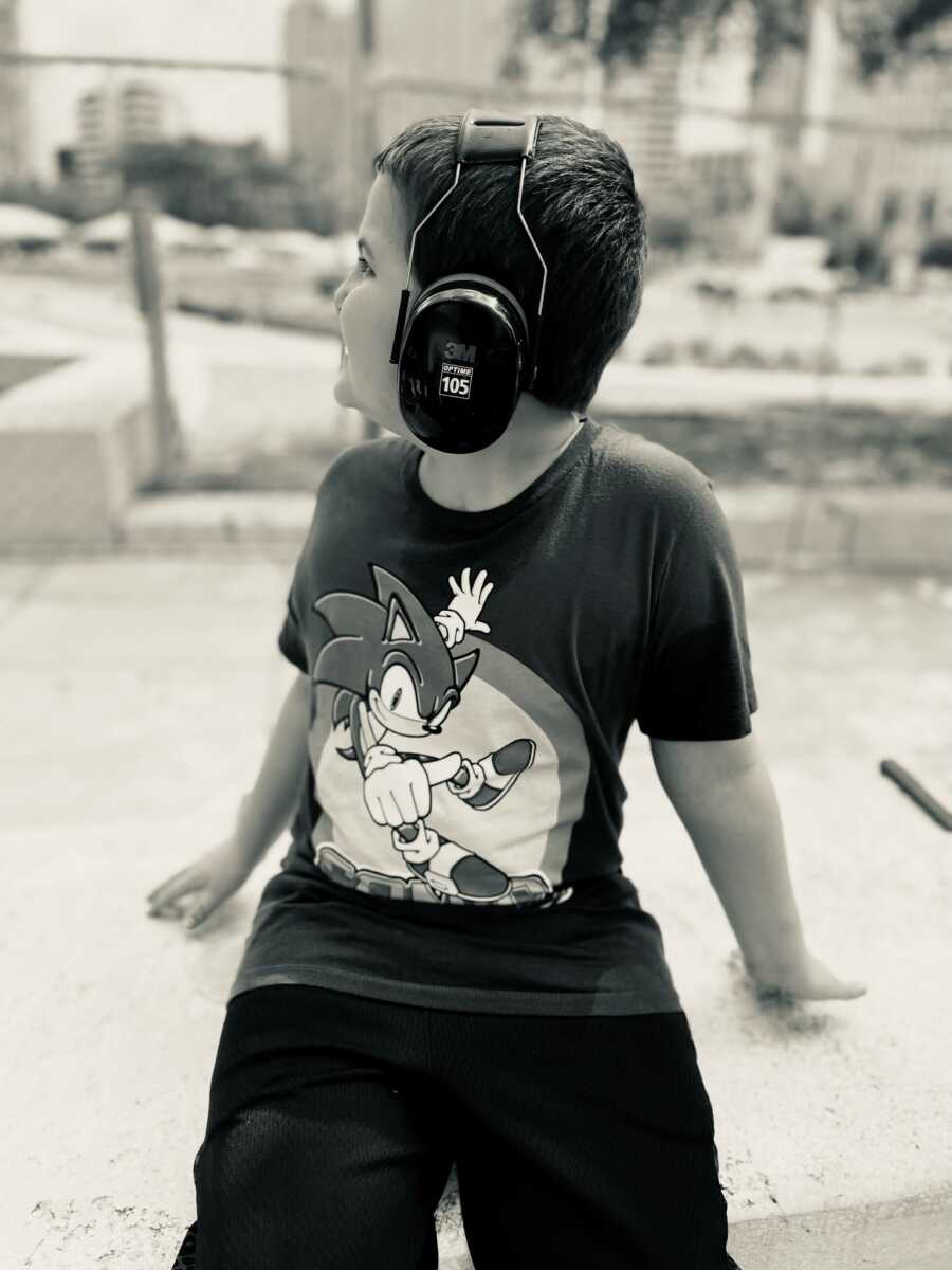 little boy with ear muffs