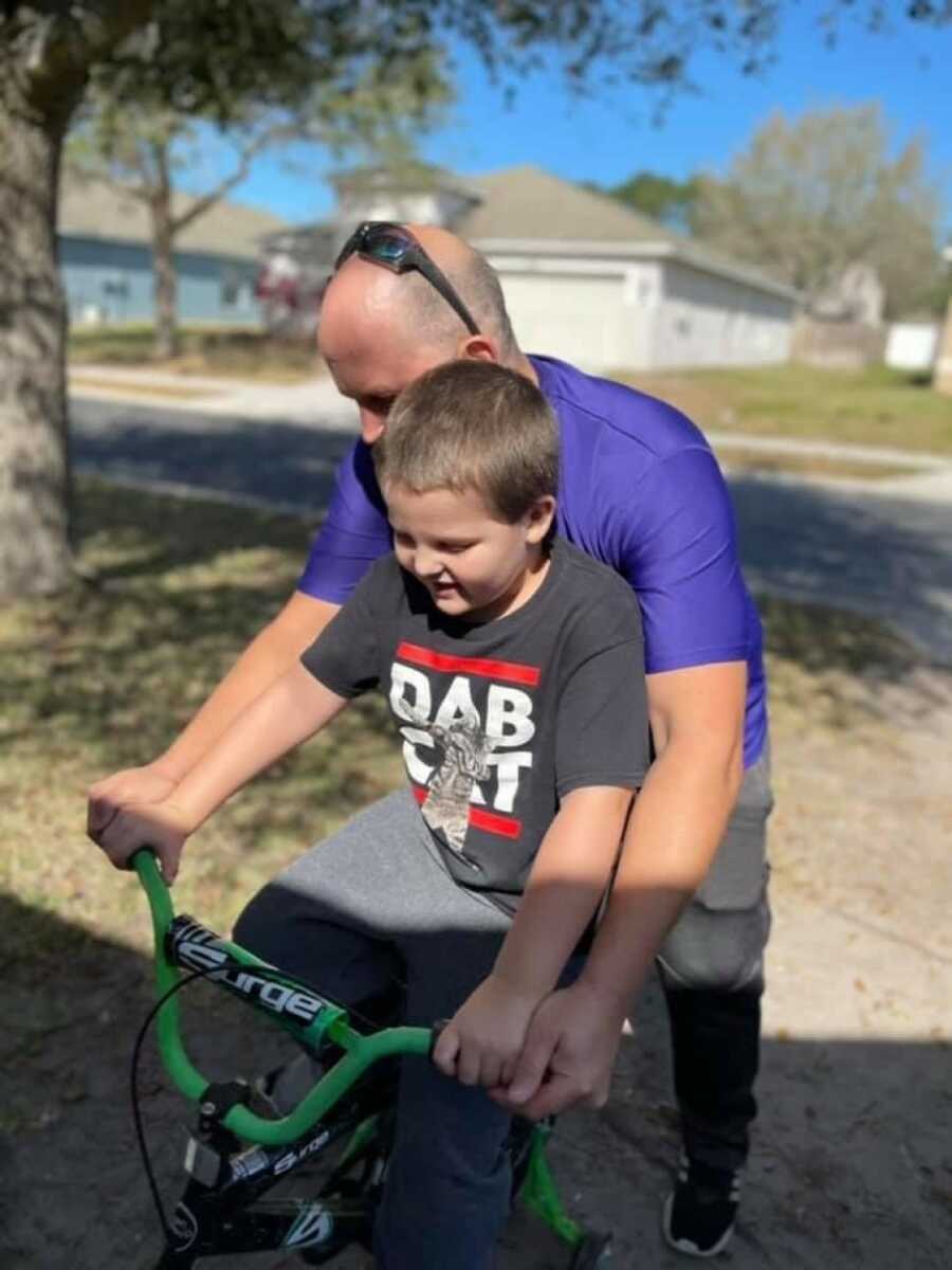 dad and son riding a bike