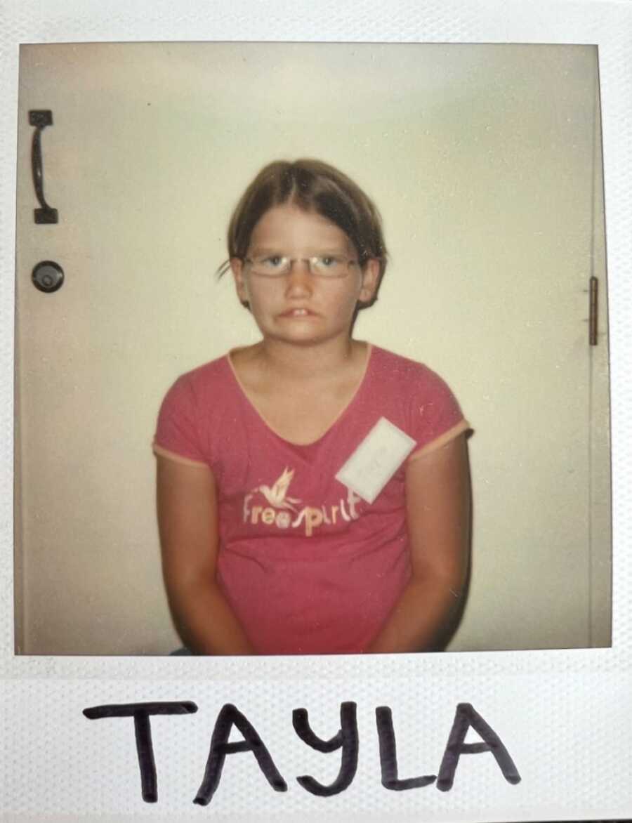 little girl posing for a polariod